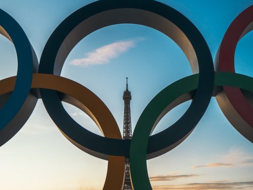 the olympic rings in front of the eiffel tower