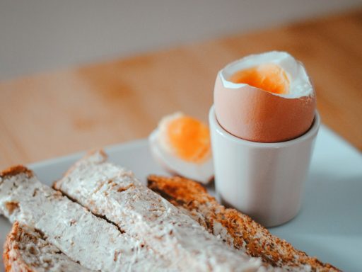 bread with egg on white ceramic plate