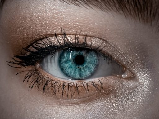 persons blue eyes in close up photography