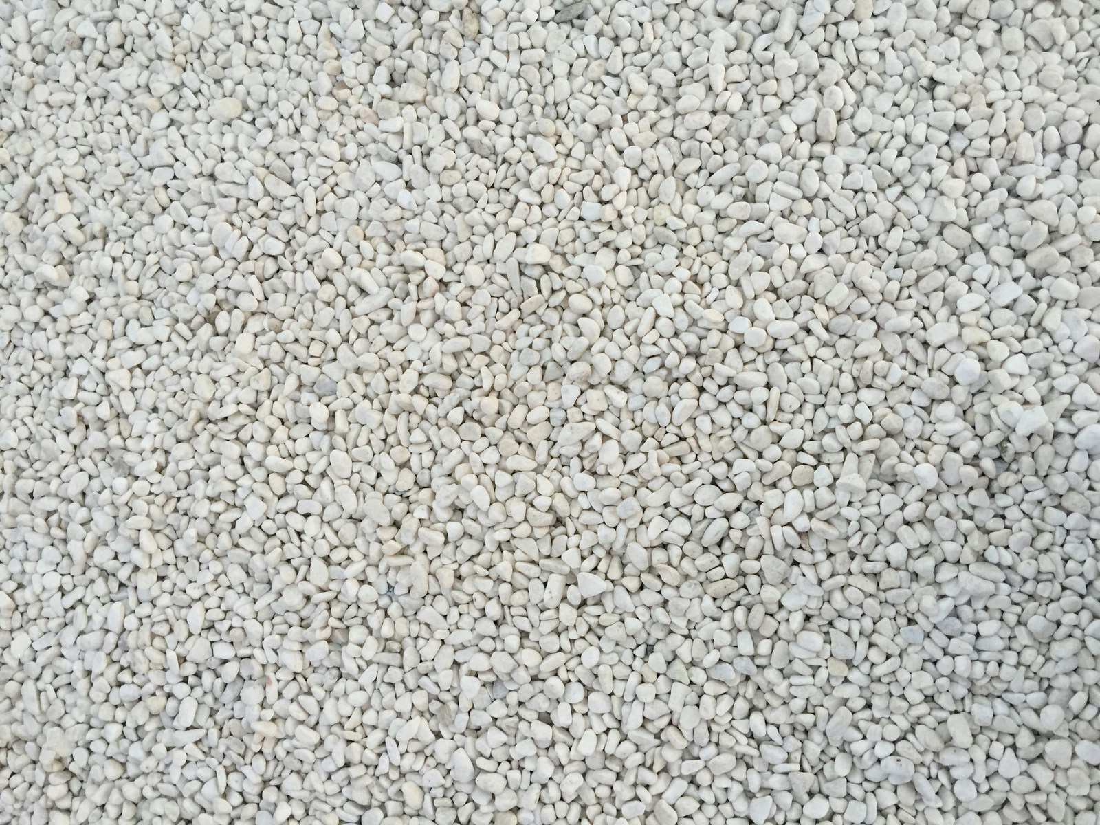 a close up of a white carpet with small rocks