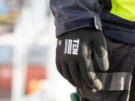 a person wearing a safety jacket and gloves